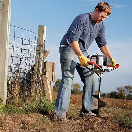 Man drilling a hole using an Earth Auger