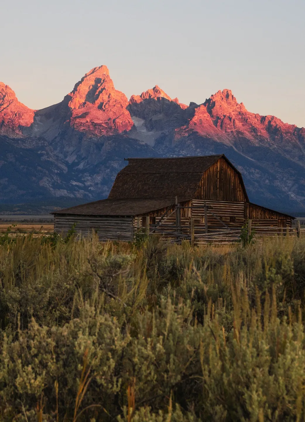 A wooden barn with a mountain view